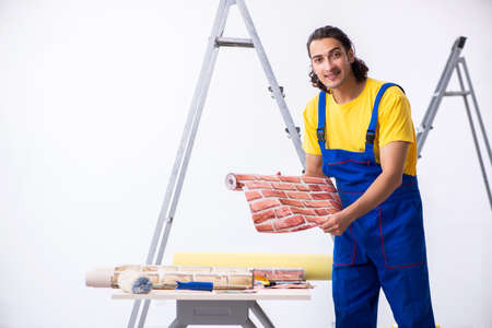 Young man contractor doing renovation at homeの写真素材