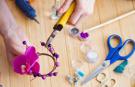 Woman making jewelry at home