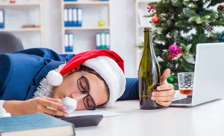 Businessman celebrating christmas holiday in the officeの写真素材