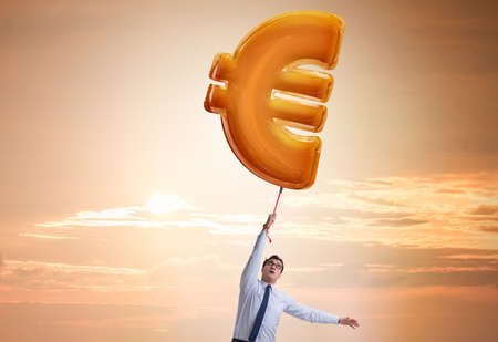 Businessman flying on euro sign inflatable balloonの写真素材