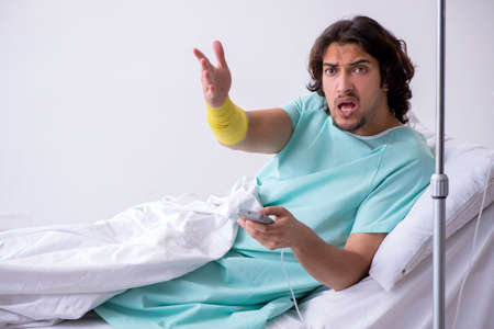 Young man staying in hospital in transfusion conceptの写真素材