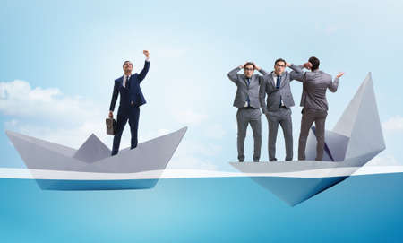 Businessman escaping sunken paper boat shipの写真素材