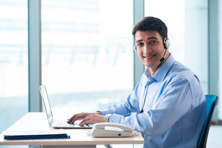 Male call-center operator in business concept