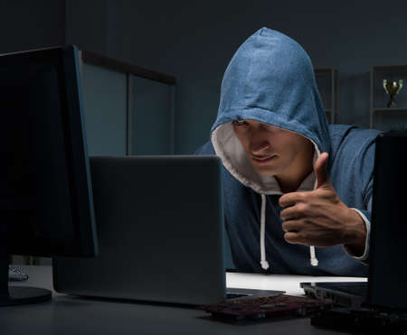 Hacker hacking computer at night