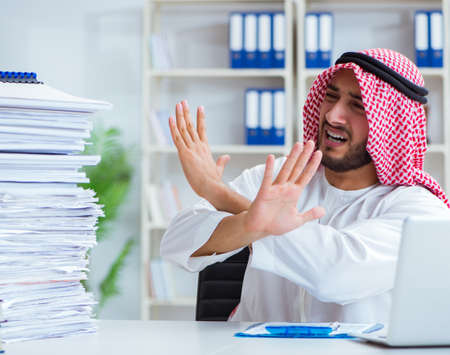 Arab businessman working in the office doing paperwork with a piの写真素材