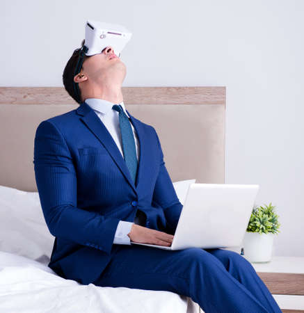 Businessman wearing a virtual reality headset in the bedroomの写真素材