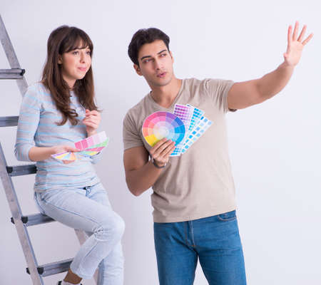 The young family doing renovation at home - painting wallsの写真素材