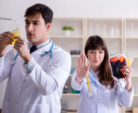 Two doctors discussing plasma and blood transfusionの写真素材