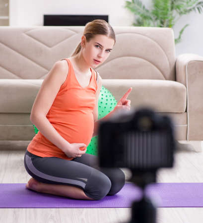 Pregnant woman recording video for blog and vlogの写真素材