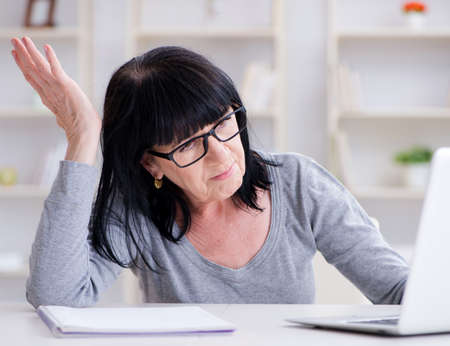 Senior woman struggling at computer