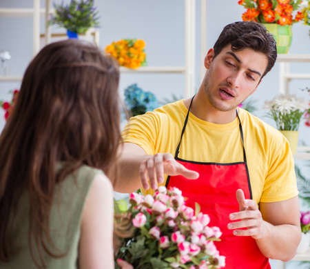 Florist selling flowers in a flower shopの写真素材