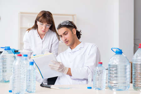 Two chemists working in the lab