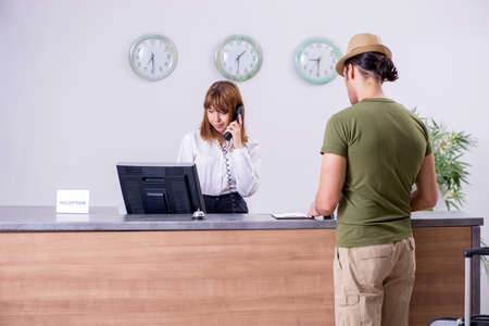 Young man at the hotel receptionの写真素材