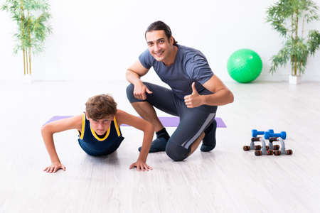 Young father and his son doing exercisesの写真素材