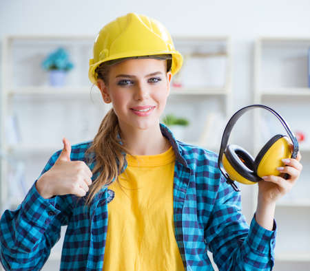 Woman in workshop with noise cancelling headphonesの写真素材