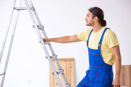 Young male contractor working indoorsの写真素材