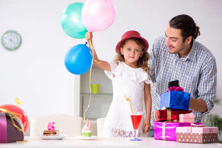 Father celebrating birthday with his daughterの写真素材