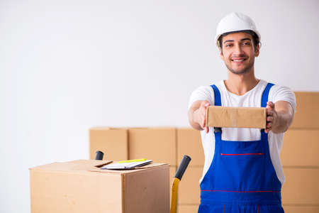 Young male professional mover doing home relocationの写真素材