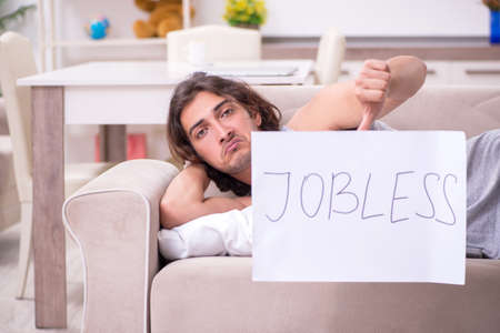 Unemployed man desperate at homeの写真素材