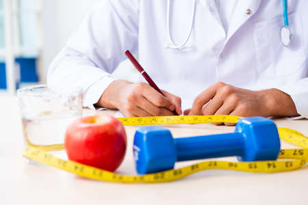 The young male doctor in sport and dieting conceptの写真素材