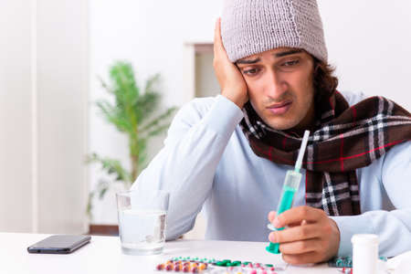 Young man suffering from flu at home