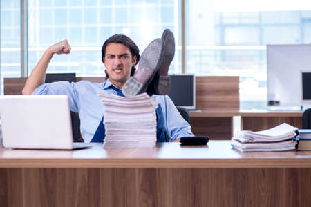 Young employee unhappy with excessive workの写真素材