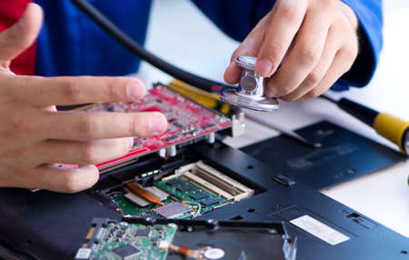 Repairman working in technical support fixing computer laptop troubleshooting