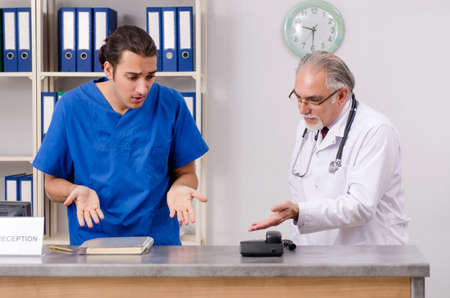 Two doctors talking at the reception in hospital