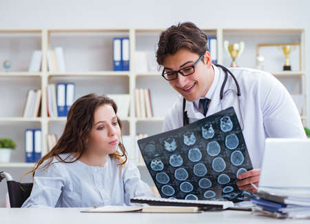 Doctor explaining to patient results of x-ray imagingの写真素材