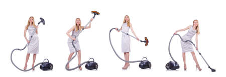 Young woman with vacuum cleaner on whiteの写真素材