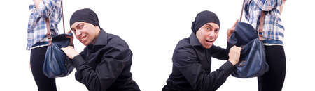 Young thief stealing womans bagの写真素材