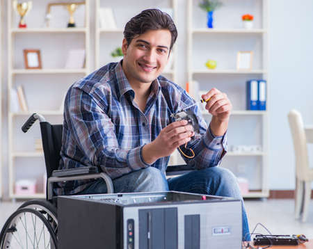 Computer repairman on wheelchair working