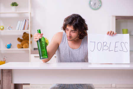 Unemployed man desperate at homeの写真素材