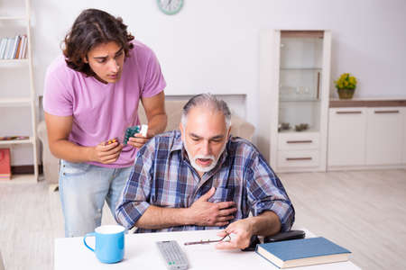 Young student and his old grandpa at home