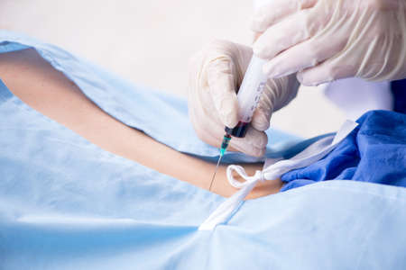 The female patient getting an injection in the clinicの写真素材