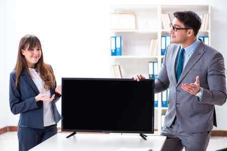 Young employee making presentation to his female bossの写真素材