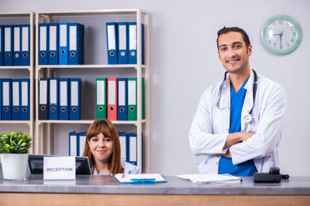 Two doctors working at the reception in the hospitalの写真素材