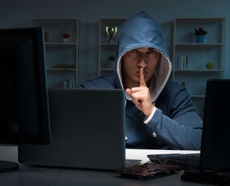 The hacker hacking computer at night