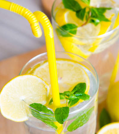 Glasss of mojito with lemon and drinking strawの写真素材