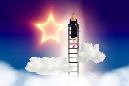The businesswoman reaching out for stars in success conceptの写真素材