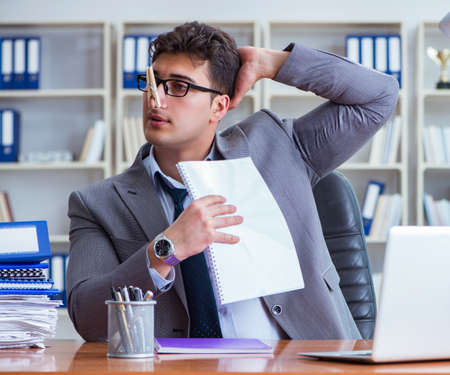 Businessman sweating excessively smelling bad in office at workpの写真素材