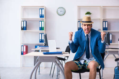 Young employee escaping for summer vacationの写真素材