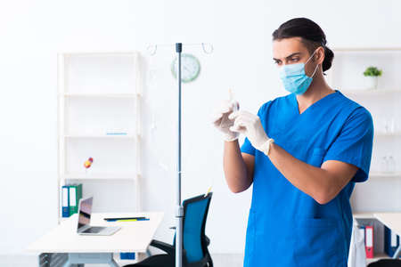 Young male doctor working in the clinicの写真素材
