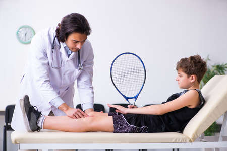 Boy tennis player visiting young doctor traumatologistの写真素材