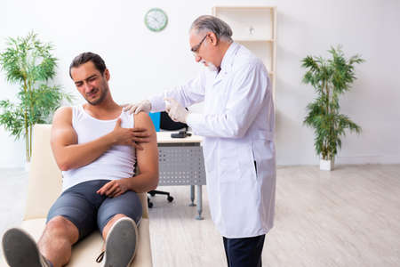 Young male patient visiting experienced doctorの写真素材