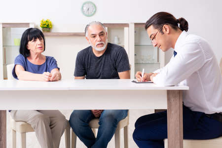 Financial advisor giving retirement advice to old coupleの写真素材