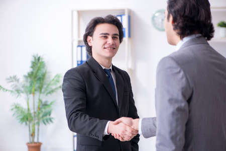 Two young businessmen meeting in the officeの写真素材