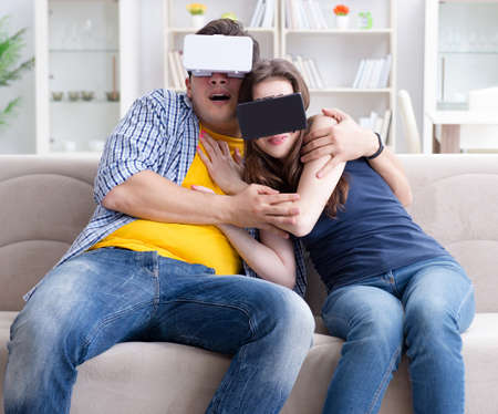 Young family playing games with virtual reality glasses