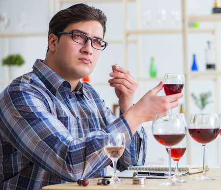 Professional sommelier tasting red wine