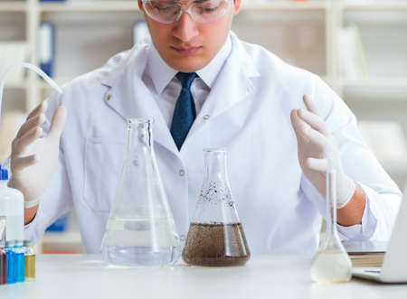 Young researcher scientist doing a water test contamination expeの写真素材